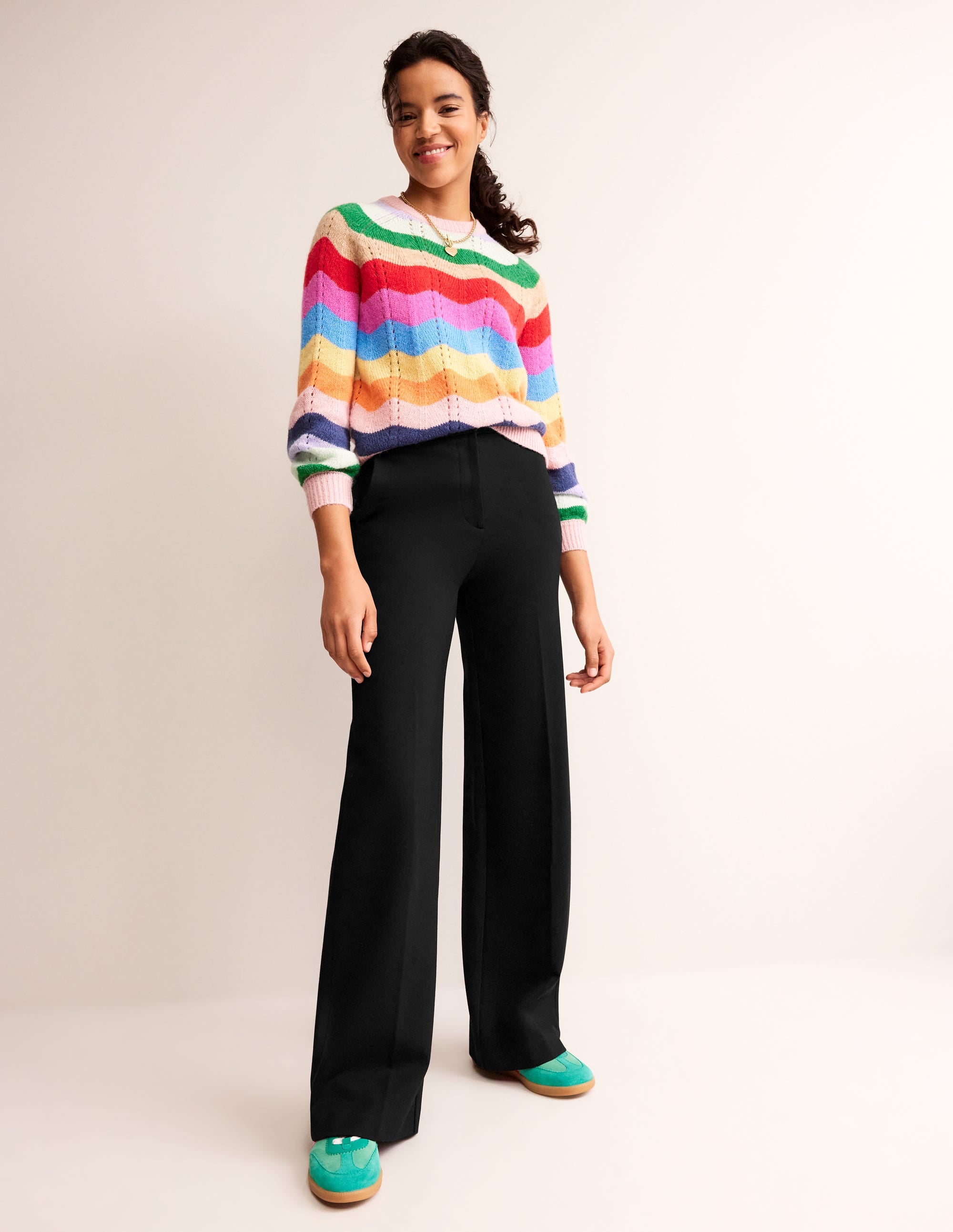 A pair of black women's wide-leg trousers with front-pressed creases, made from ponte fabric.