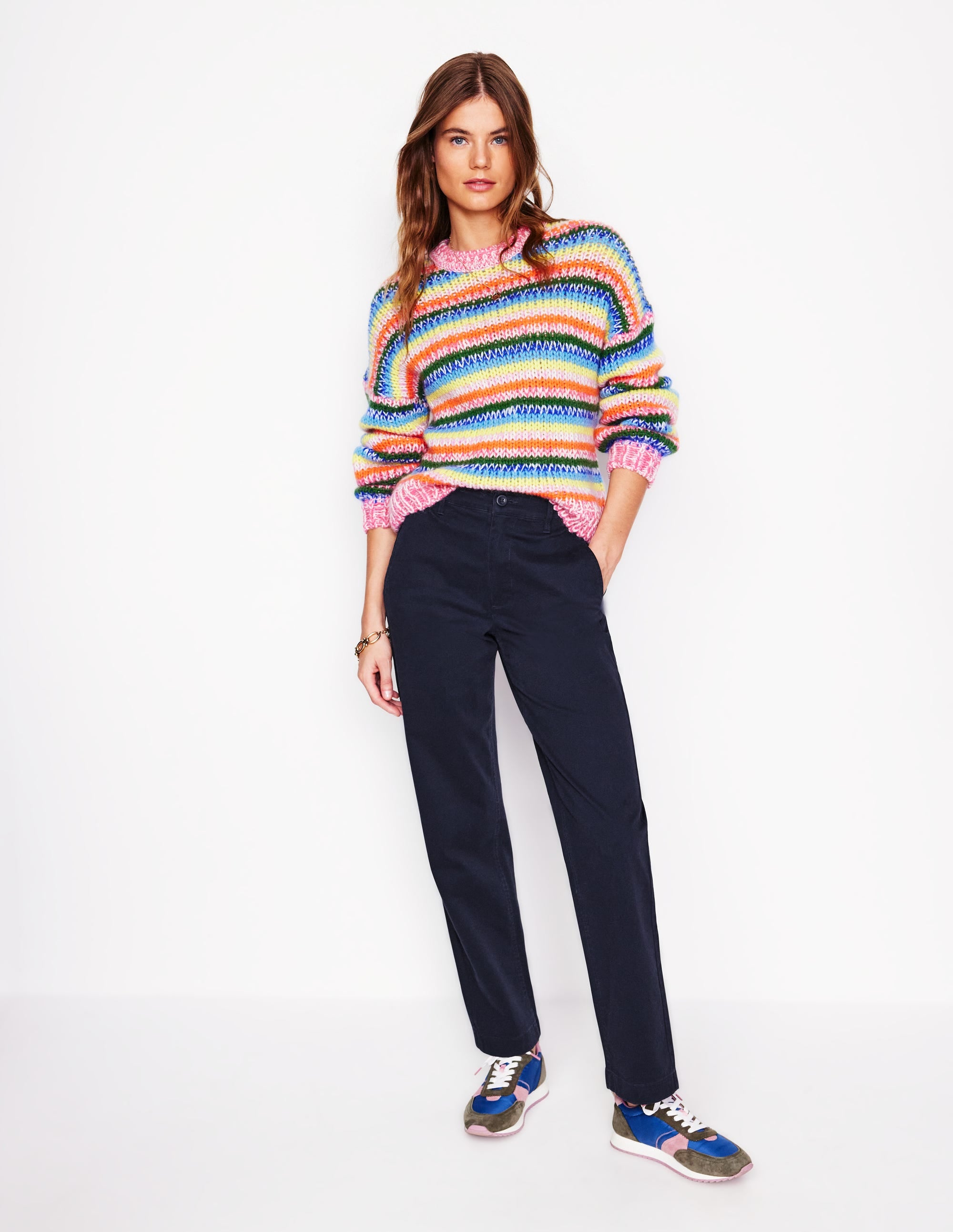 A pair of navy women's chino trousers with a slim, straight fit, sitting at the natural waist, with functional pockets, a button closure, and a zipped fly.