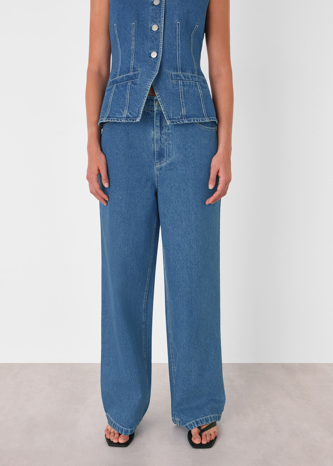A pair of medium-wash denim women's jeans with a relaxed straight-leg fit, high waist, and classic five-pocket design.
