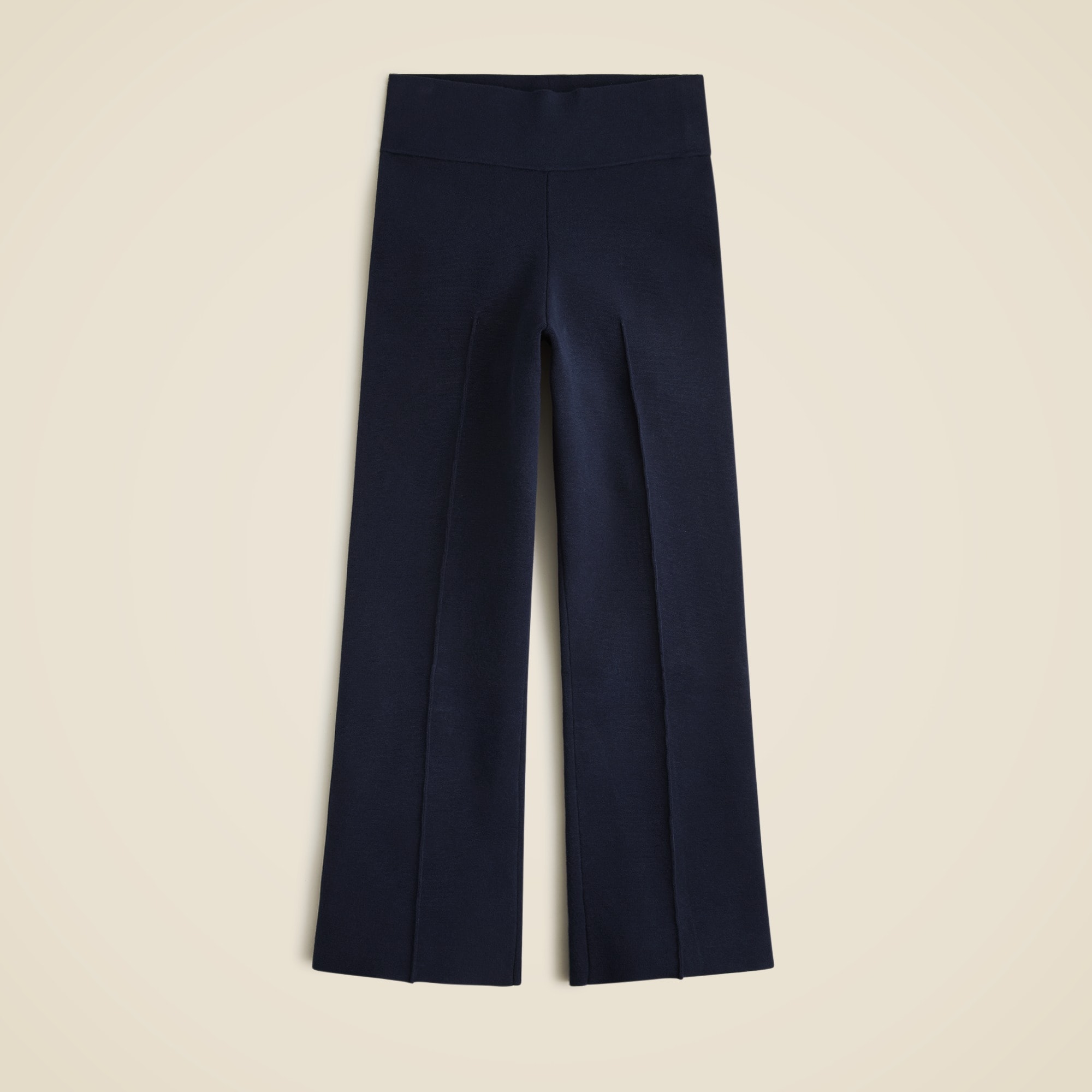 Navy blue high-rise fitted pants with pintuck details and elastic waistband.