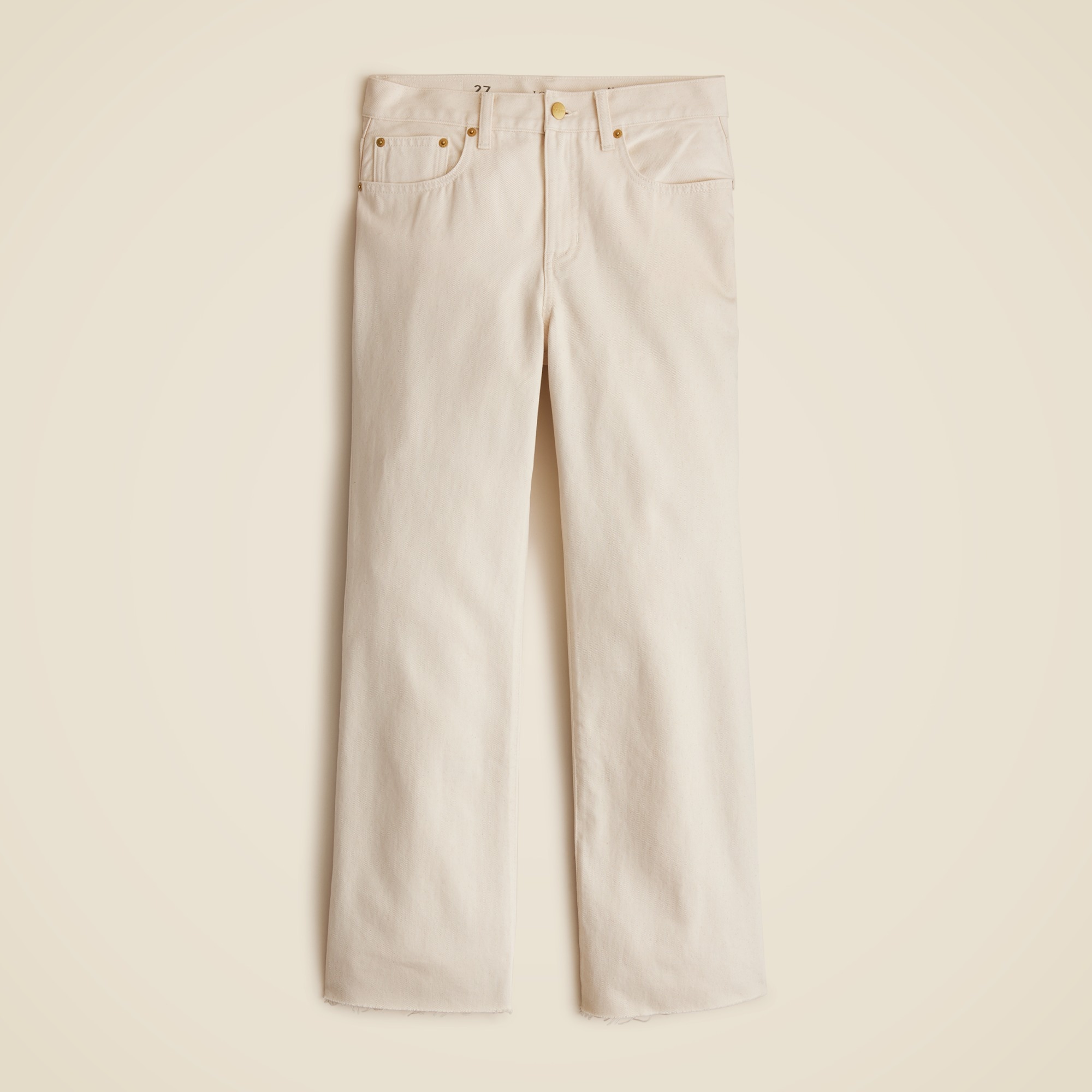 Beige mid-rise relaxed kickout jeans with five pockets and a high waist, laid flat.
