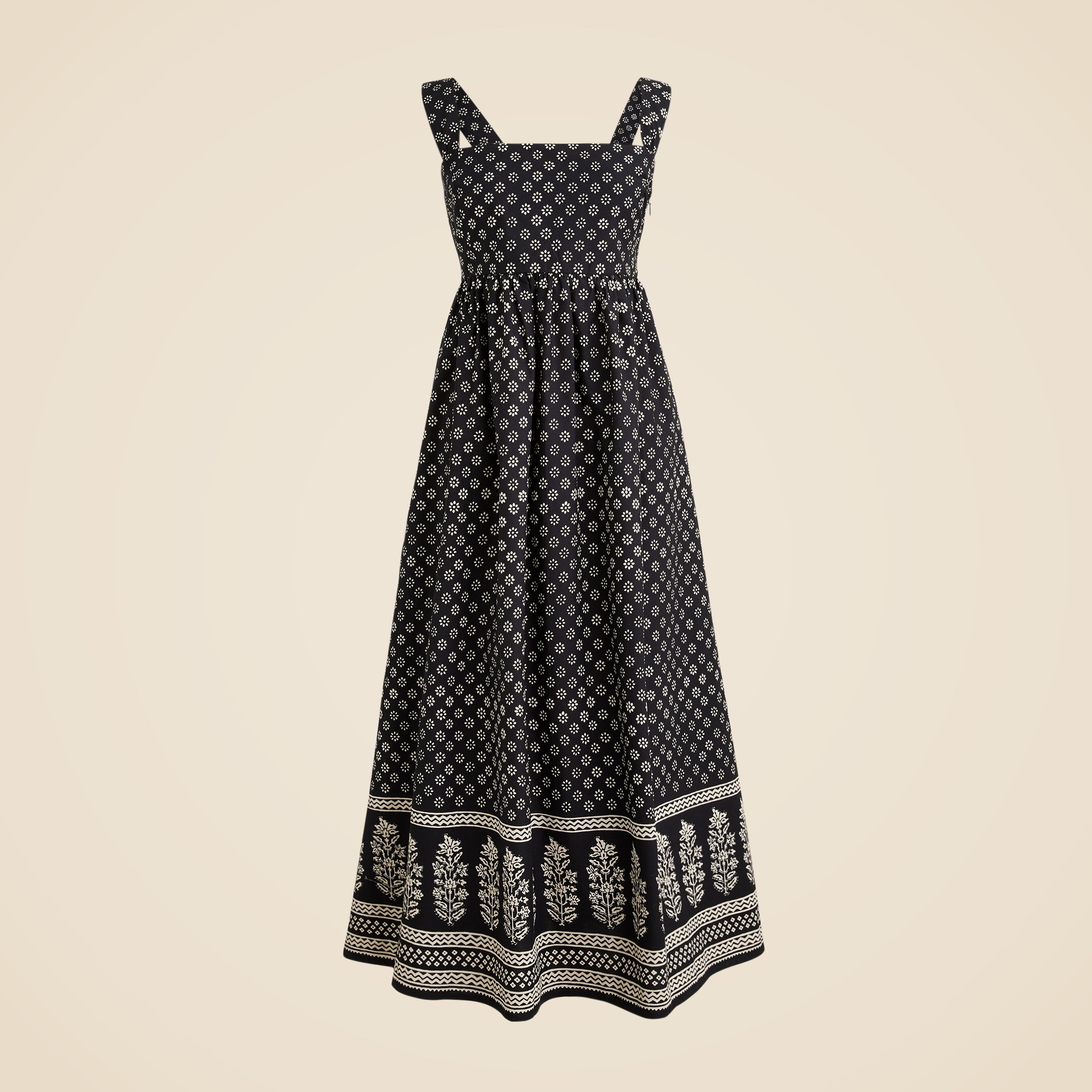 A women's midi dress with a square neckline, sleeveless straps, and a black and white block print pattern. The dress has a fitted bodice and a flowing A-line skirt with a decorative border at the hem.