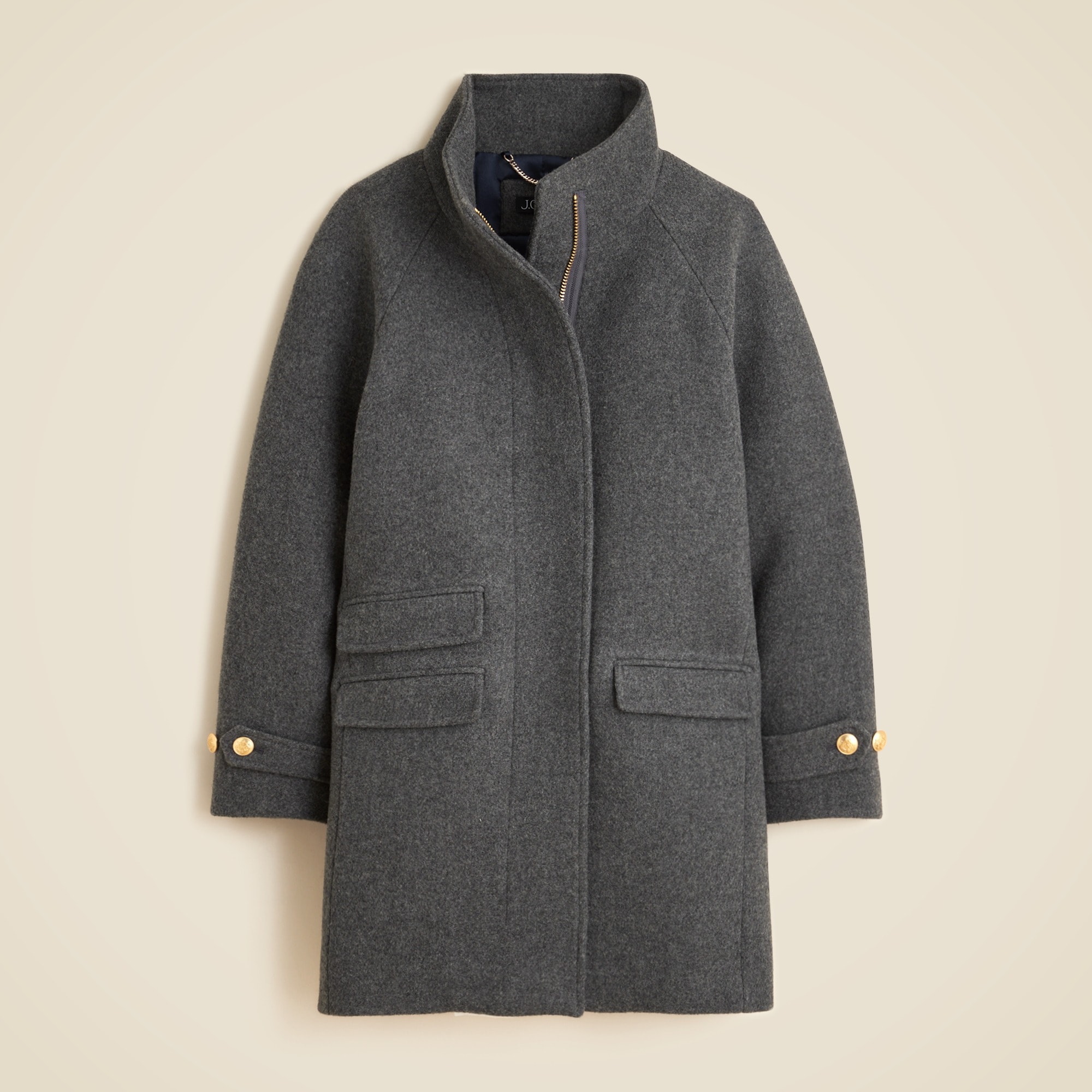 A women's Toscana coat in grey, featuring a cocoon fit, standing collar, hidden zipper, crest buttons, and lining.