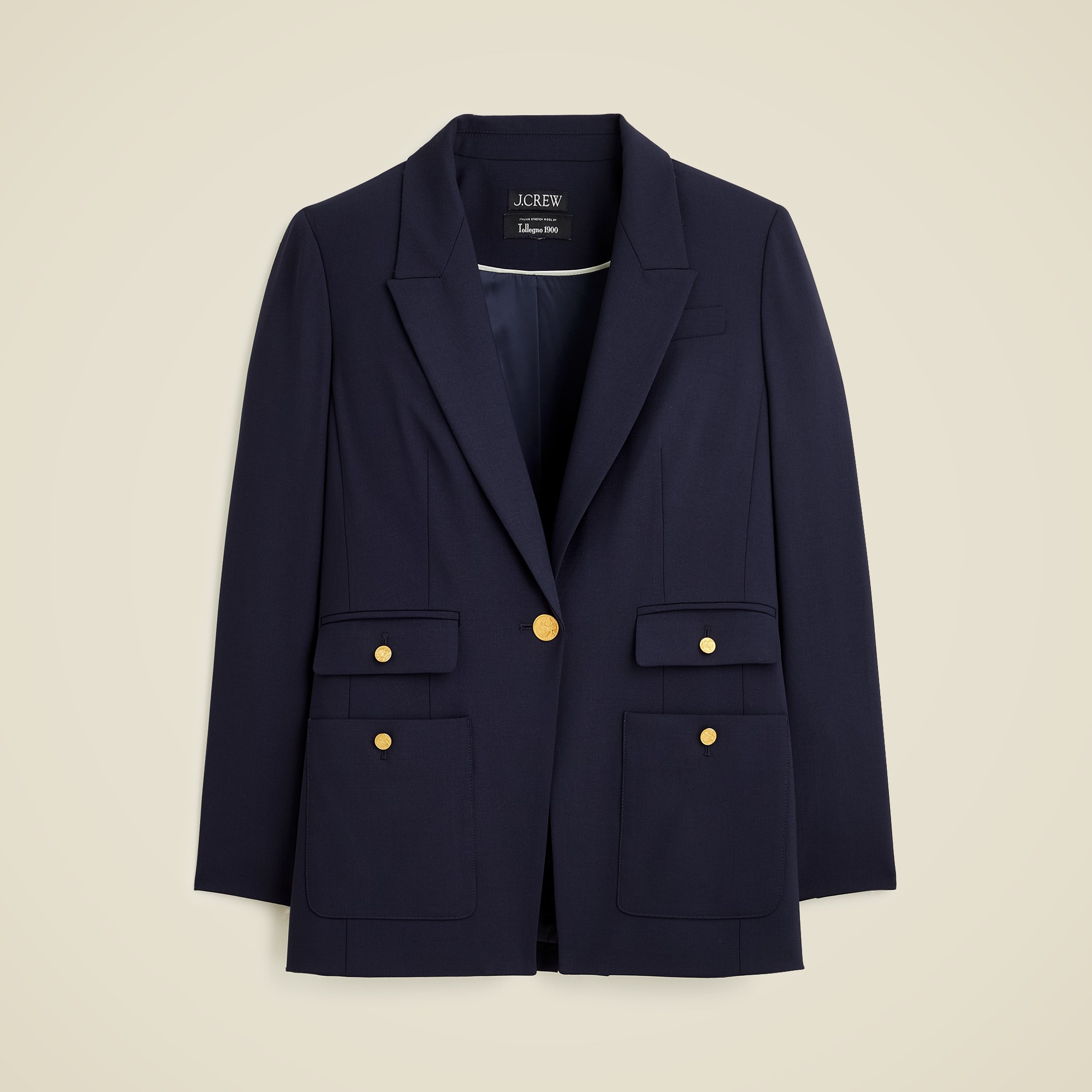 A navy blazer with gold buttons, patch pockets, and a tailored lapel, made from Italian bi-stretch wool blend fabric.