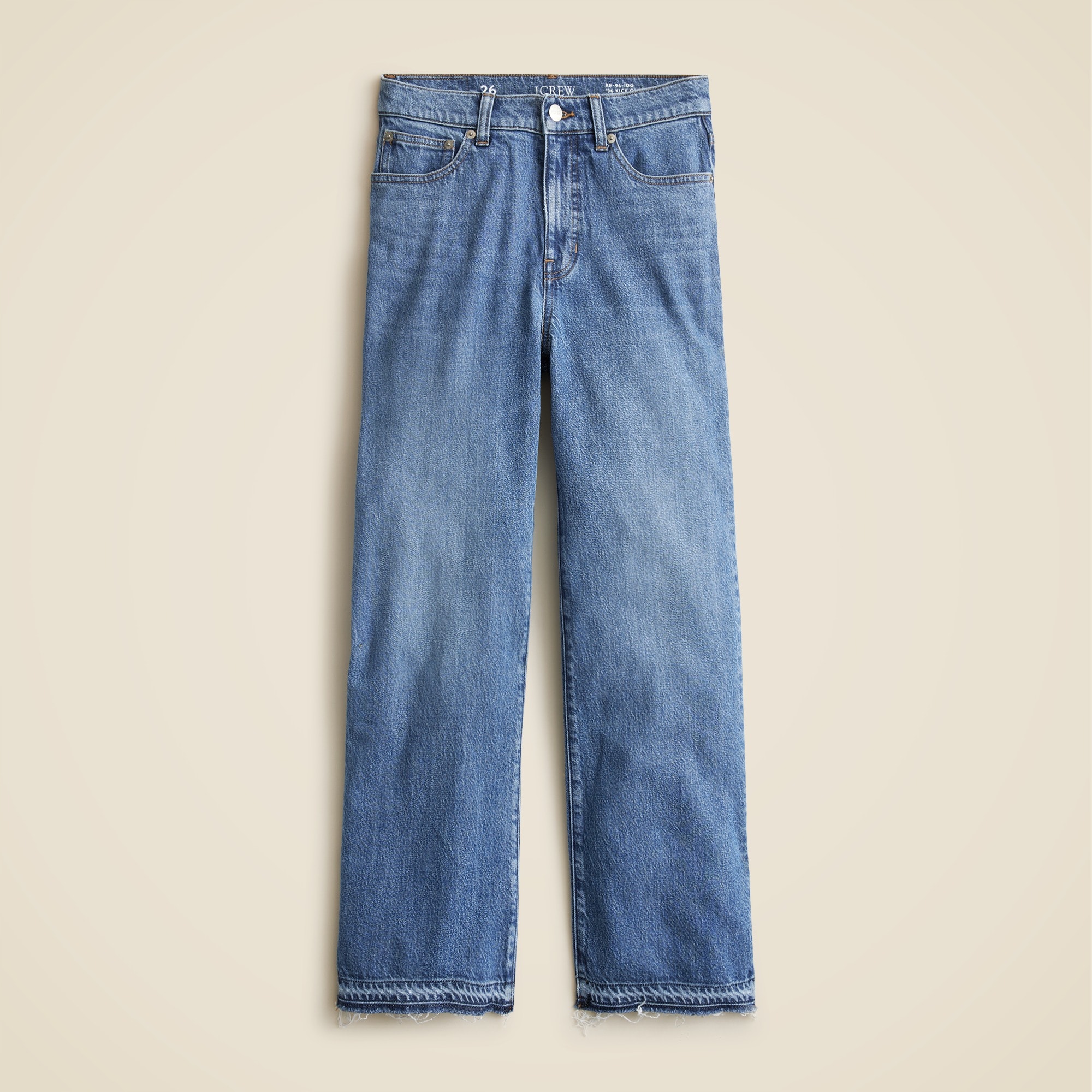 A pair of blue high-rise kickout jeans with a raw hem, slim fit, and five-pocket styling.