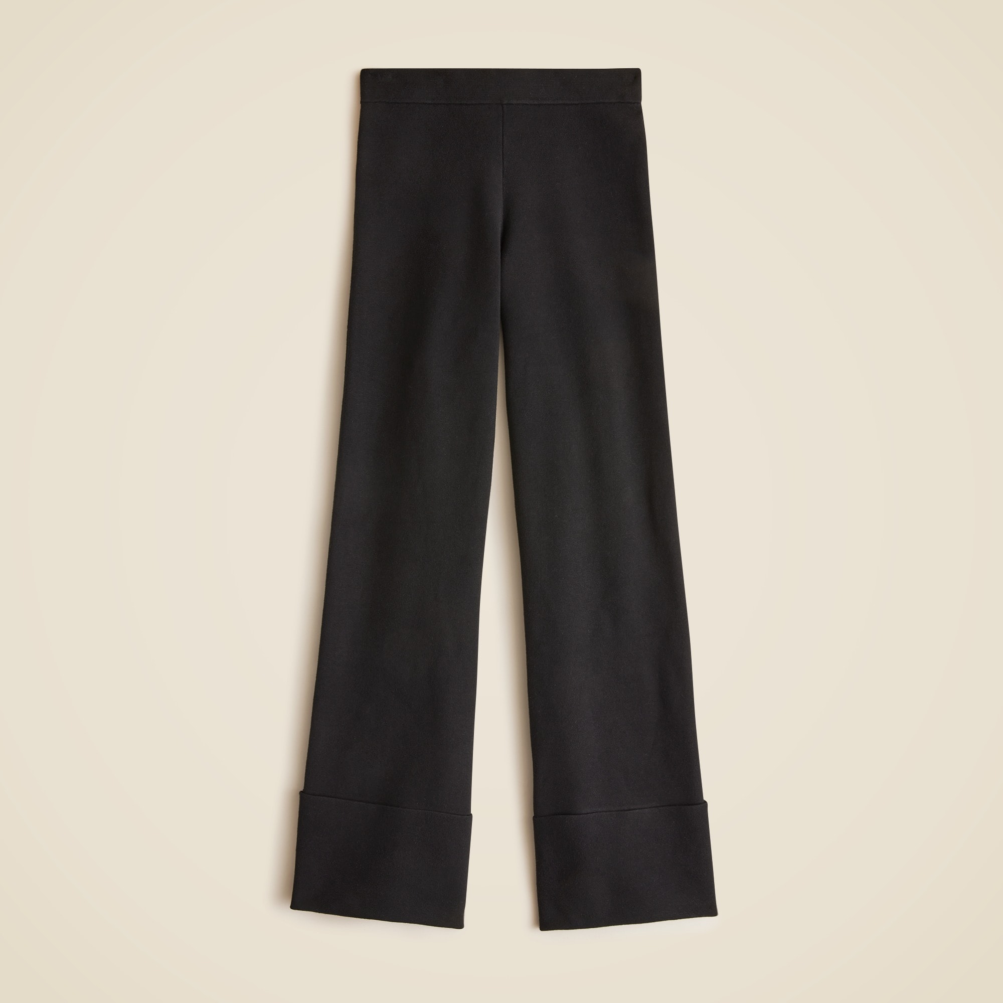 A pair of black wide-leg cuffed sweater pants with elastic waistband and cuffed hems.