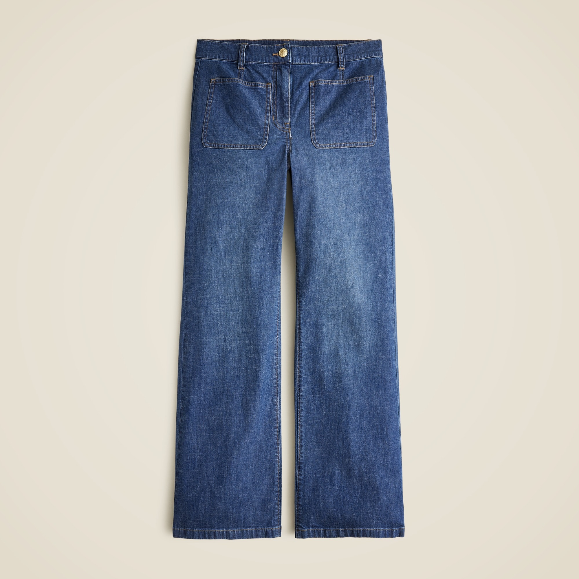 A pair of blue high-rise jeans with sailor pockets and a kickout leg, made from lightweight, drapey denim.