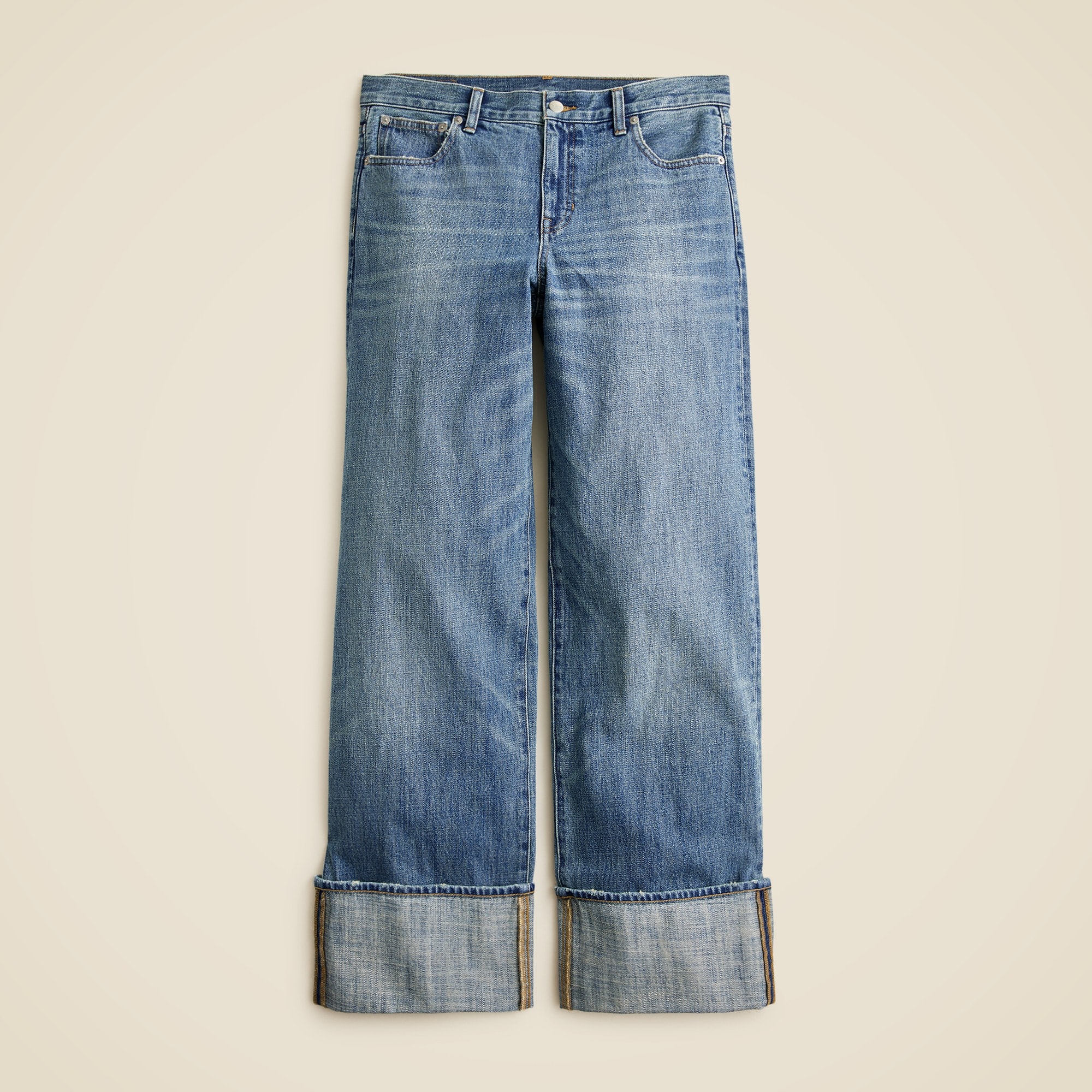 A pair of blue women's wide-leg jeans with cuffed hems, relaxed fit, and low-rise sit.
