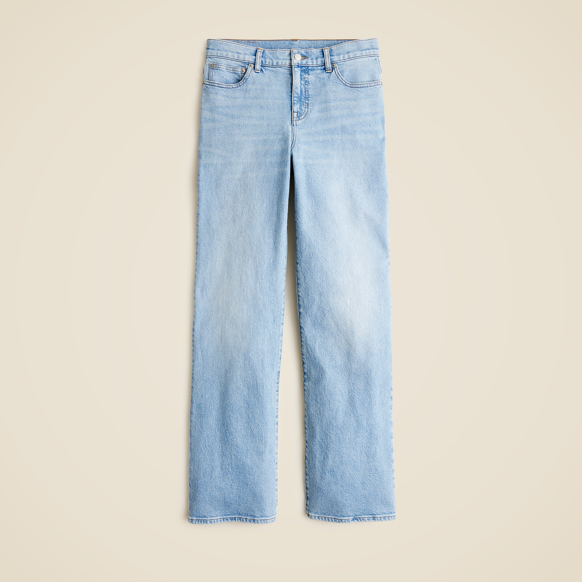 A pair of light blue jeans with a low-rise waist, five pockets, and a wide-leg design that puddles at the ankles.