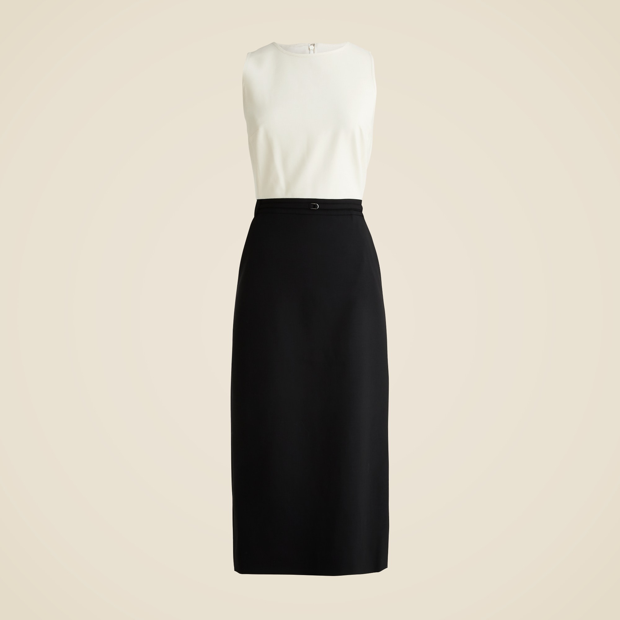 A sleeveless dress with a cream top and black skirt, featuring a fitted silhouette, back zipper, and a slim belt at the waist.