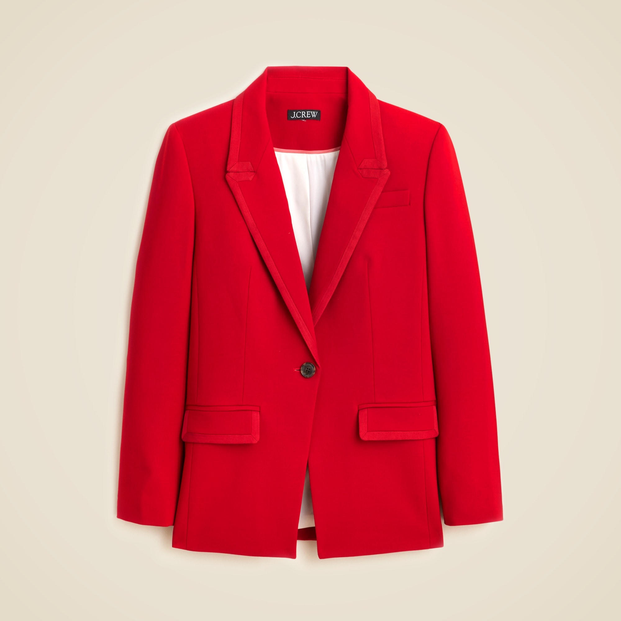 A red blazer with notched lapel, single-breasted closure, front pockets, and lining, displayed against a plain background.