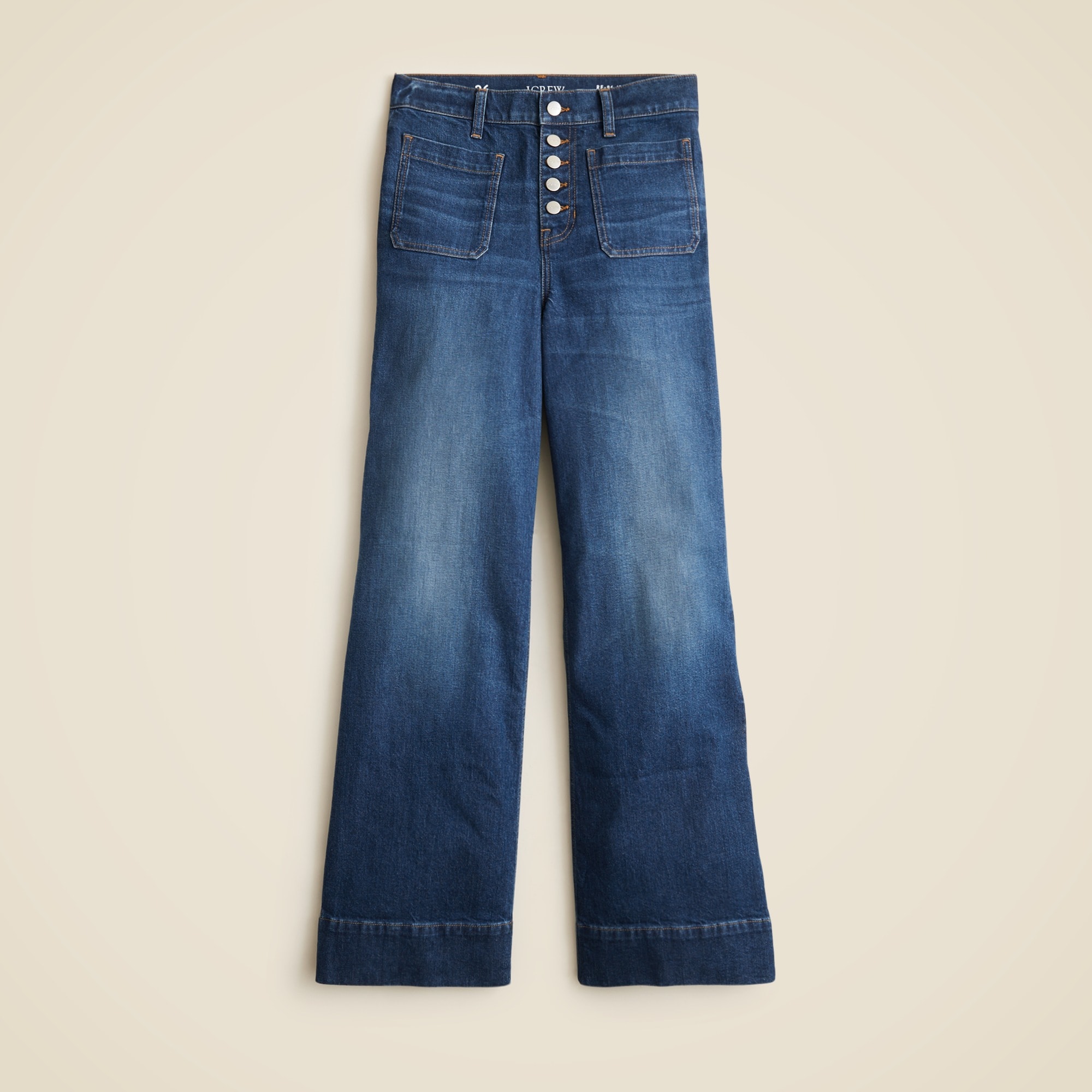 A pair of high-rise women's denim trousers with a wide-leg silhouette, button-fly closure, and classic blue wash.