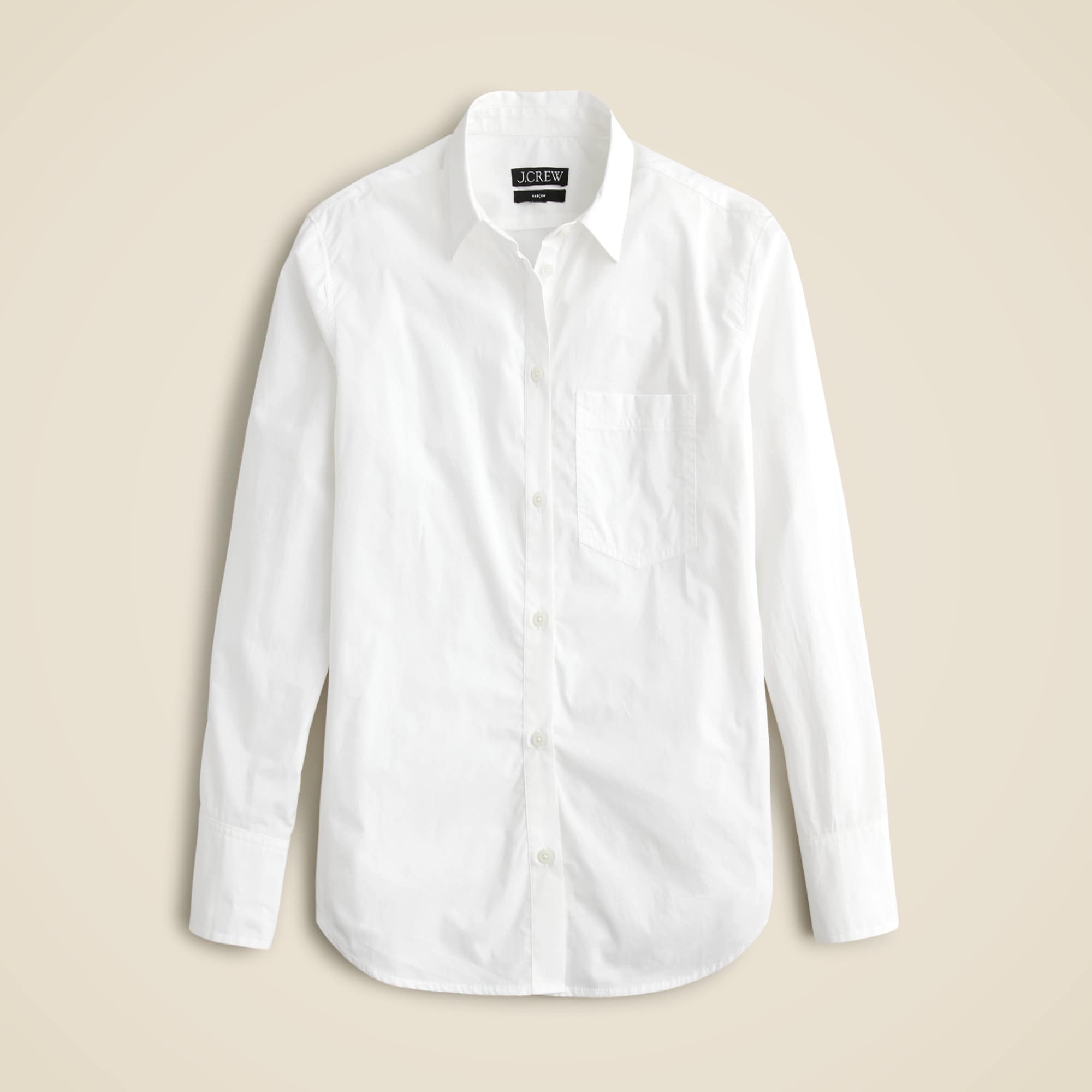 A white cotton poplin shirt with a front chest pocket and button-down collar, displayed flat.