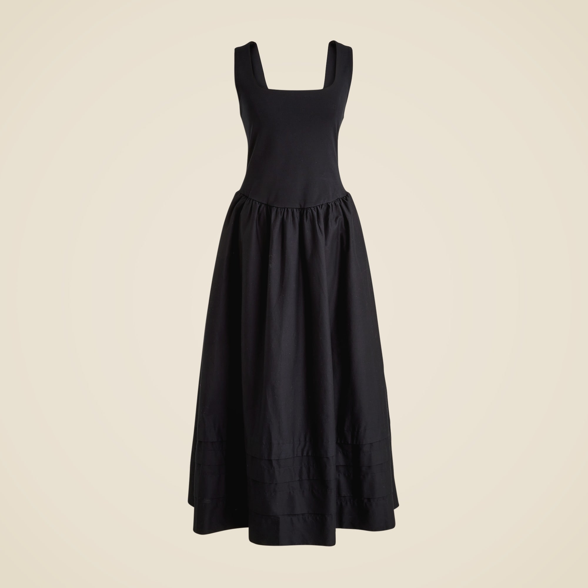 A black drop-waist women's dress with a square neckline, fitted top, and a gathered skirt with pintuck details.