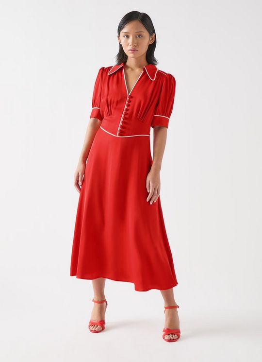 A woman wearing a red and soft pink viscose satin crepe dress with a V-neckline, puffed sleeves with contrast trim, and a flared skirt.