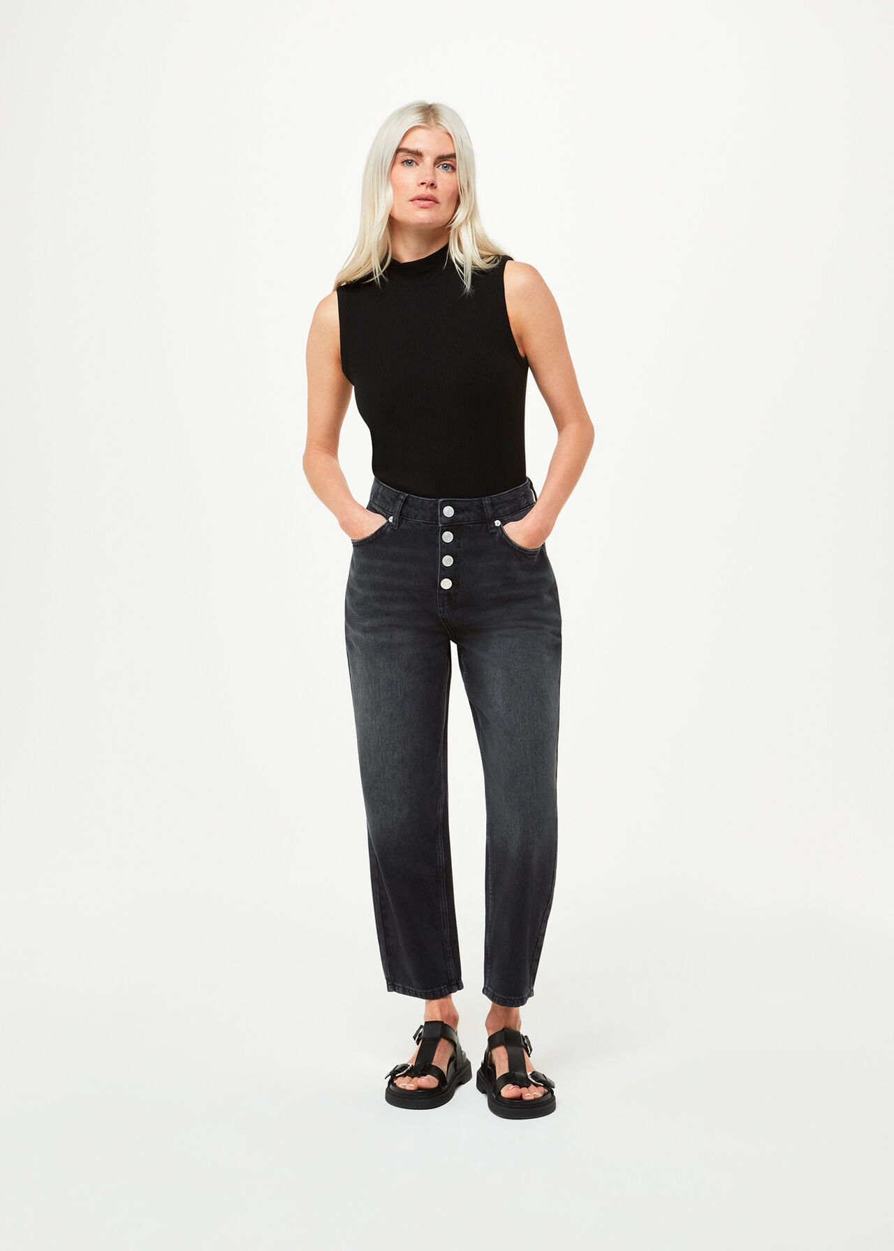 A pair of black petite high-waisted jeans with a straight leg fit, visible button closure, and a high-rise waist.