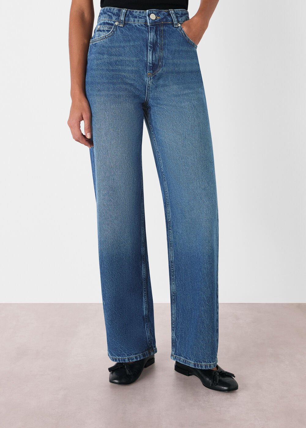 A pair of blue denim petite straight full-length jeans with a mid-waist fit, five pockets, and a classic denim wash.