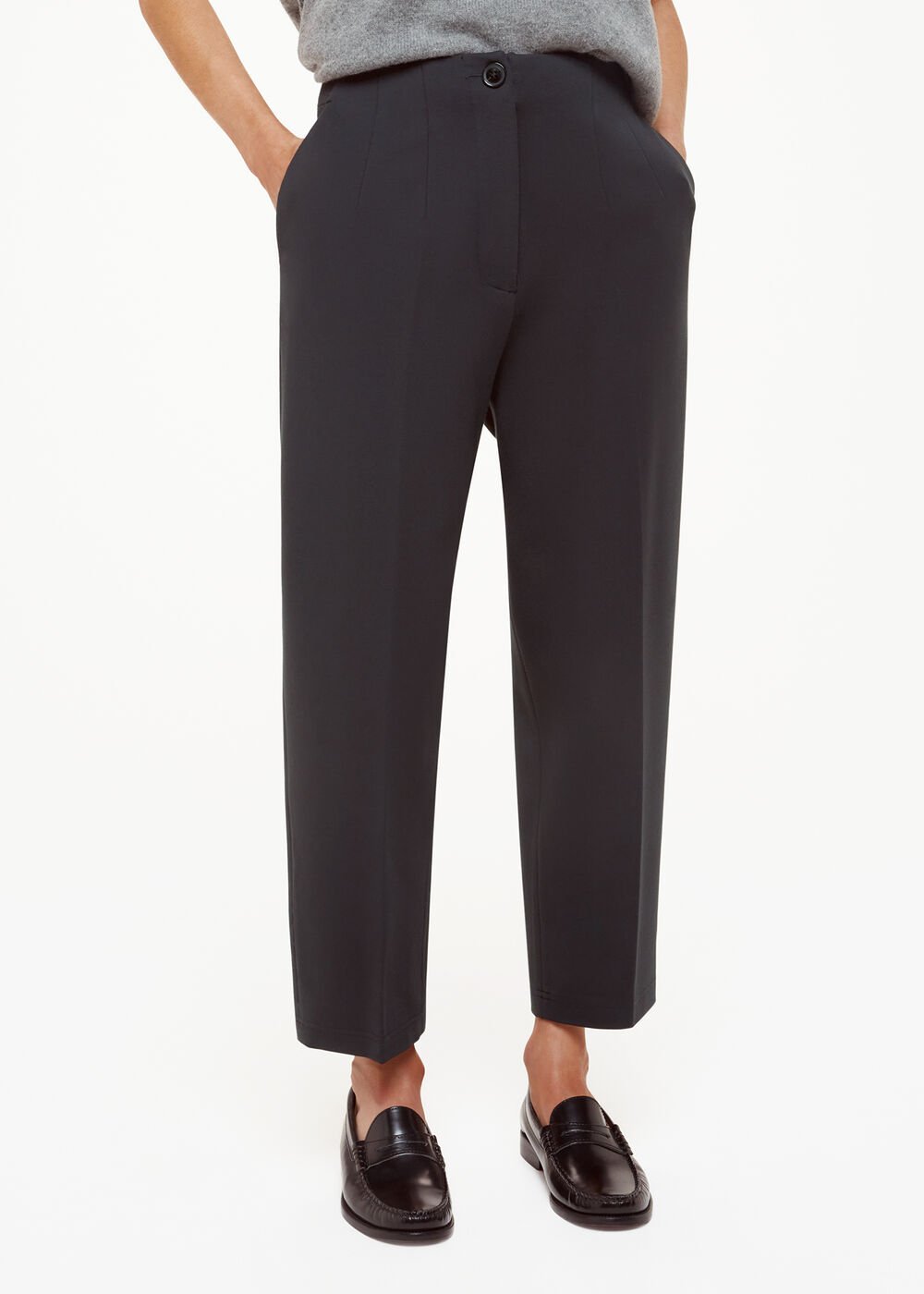 A pair of black petite Lila Ponte trousers, slim-fit, ankle-length, with a high waist and front pockets, worn with black loafers.